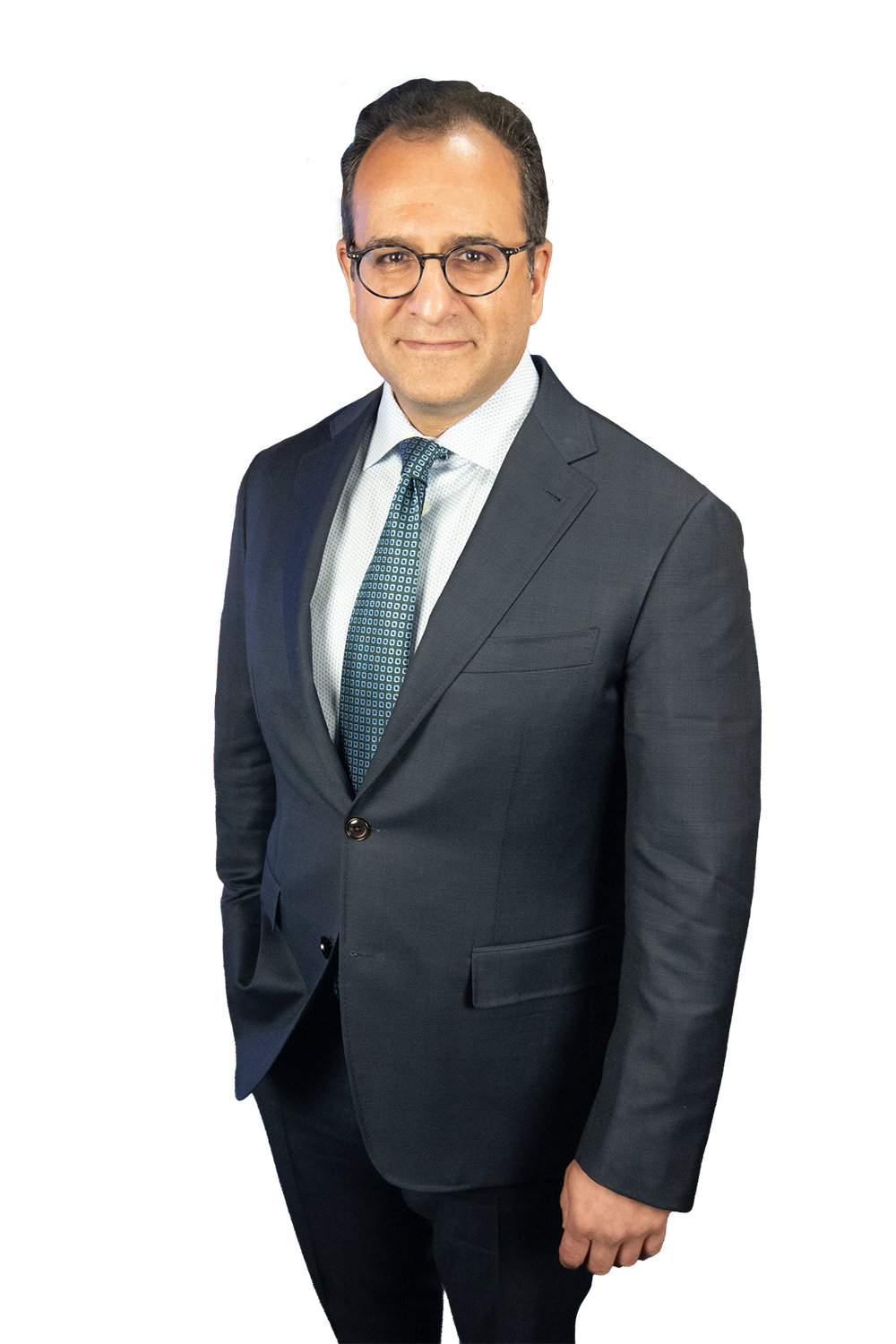 Dr. Sanil B. Nigalye, DDS, MD, of Niagara Dental Implant & Oral Surgery, wearing a dark suit, white dress shirt, and a patterned tie, stands confidently with a slight smile.